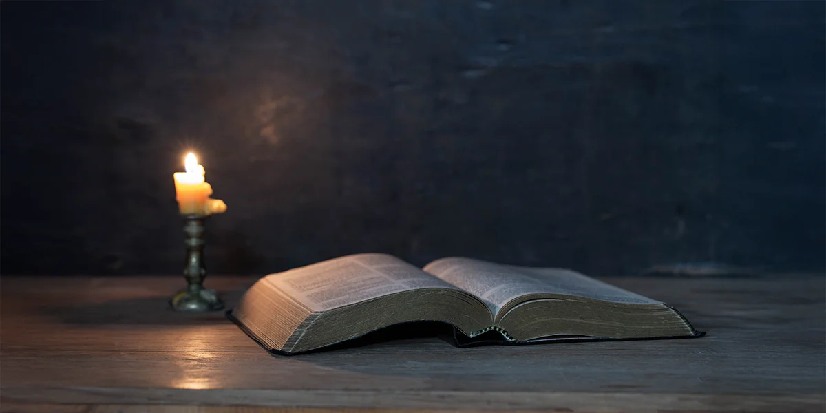 Image of an open Bible and a candle